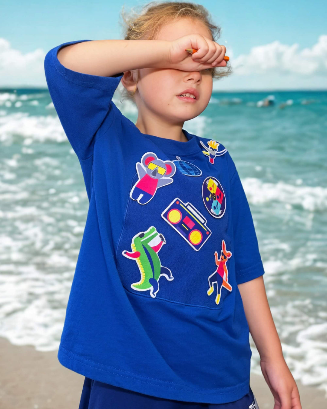 Child playing in a blue TeeBoo™ interactive kids T-shirt with the Aussie Animals Disco BooPatch™ set.