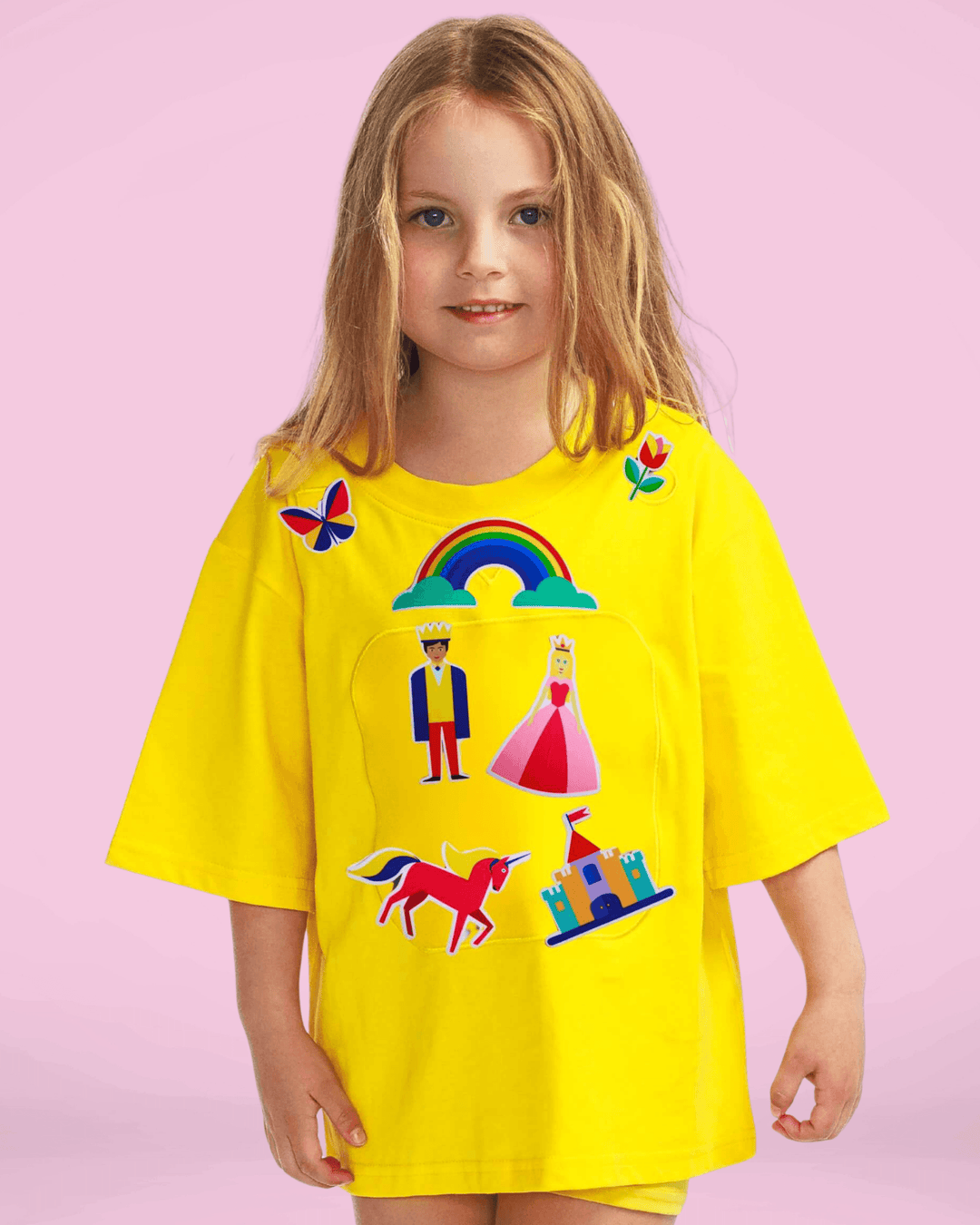 Girl wearing a yellow TeeBoo™ interactive kids T-shirt with the Fairy Sparkle BooPatch™ gift-ready set for imaginative play.