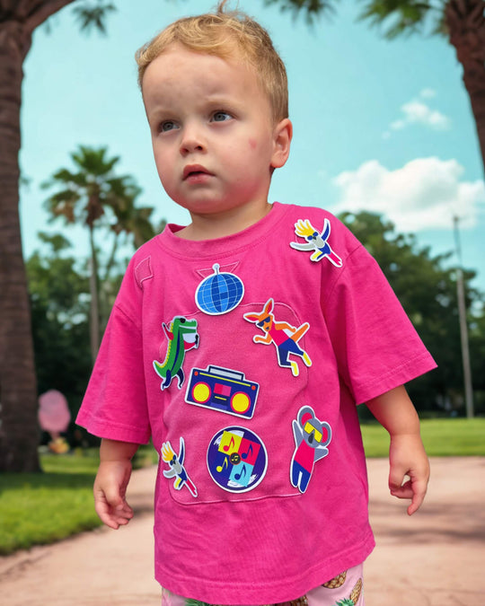 Child wearing a pink TeeBoo™ interactive kids T-shirt with the Aussie Animals Disco BooPatch™ set outdoors.