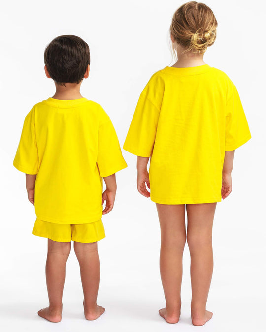 Back view of the yellow TeeBoo™ oversized organic cotton kids T-shirt from the gift-ready set.