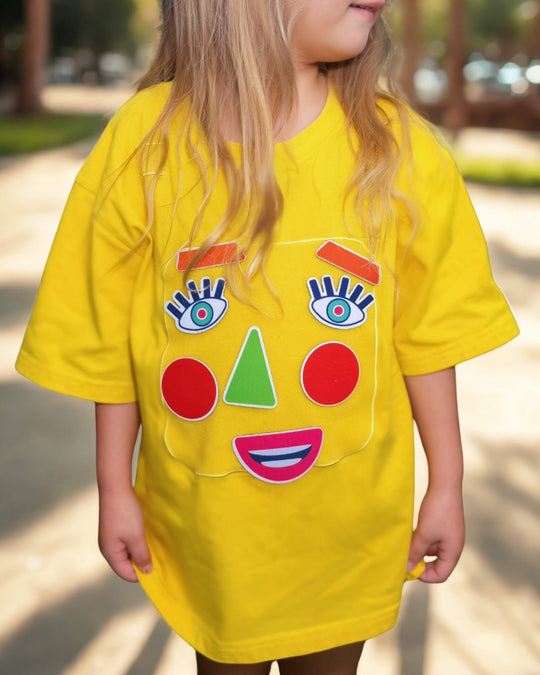 Child wearing a yellow TeeBoo™ interactive kids T-shirt with the Moody Friends BooPatch™ set during outdoor play.