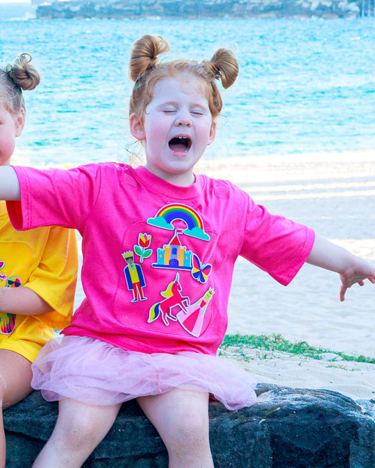 Girl wearing a pink TeeBoo™ interactive kids T-shirt with the Fairy Sparkle BooPatch™ gift-ready set.