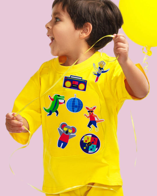 Child wearing a yellow TeeBoo™ interactive kids T-shirt with the Aussie Animals Disco BooPatch™ gift-ready set.
