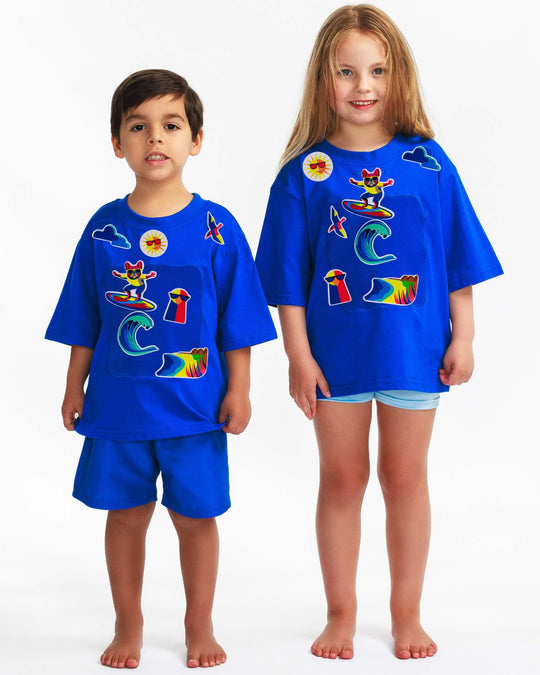 Boy and girl wearing blue TeeBoo™ interactive kids T-shirts with Sun.Fun.Surf. BooPatch™ premium gift-ready set.