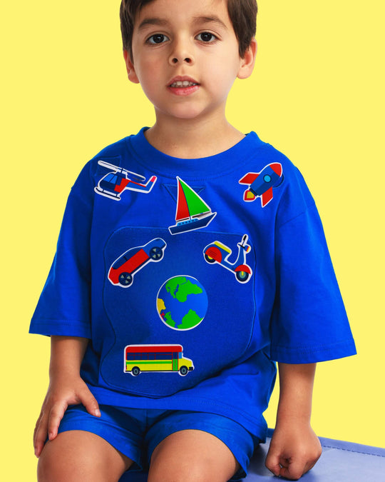 Boy wearing a blue TeeBoo™ interactive kids T-shirt with the SpeedyBoo BooPatch™ gift-ready set for creative screen-free play.