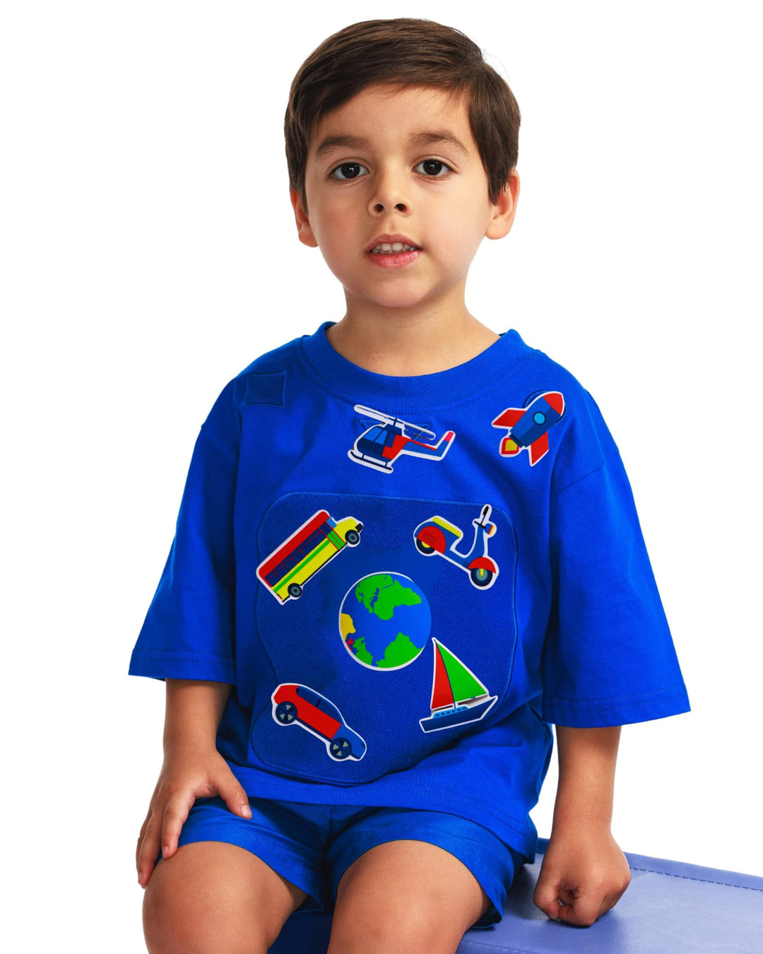 Boy wearing a blue TeeBoo™ interactive kids T-shirt with the SpeedyBoo BooPatch™ gift-ready set for creative screen-free play.