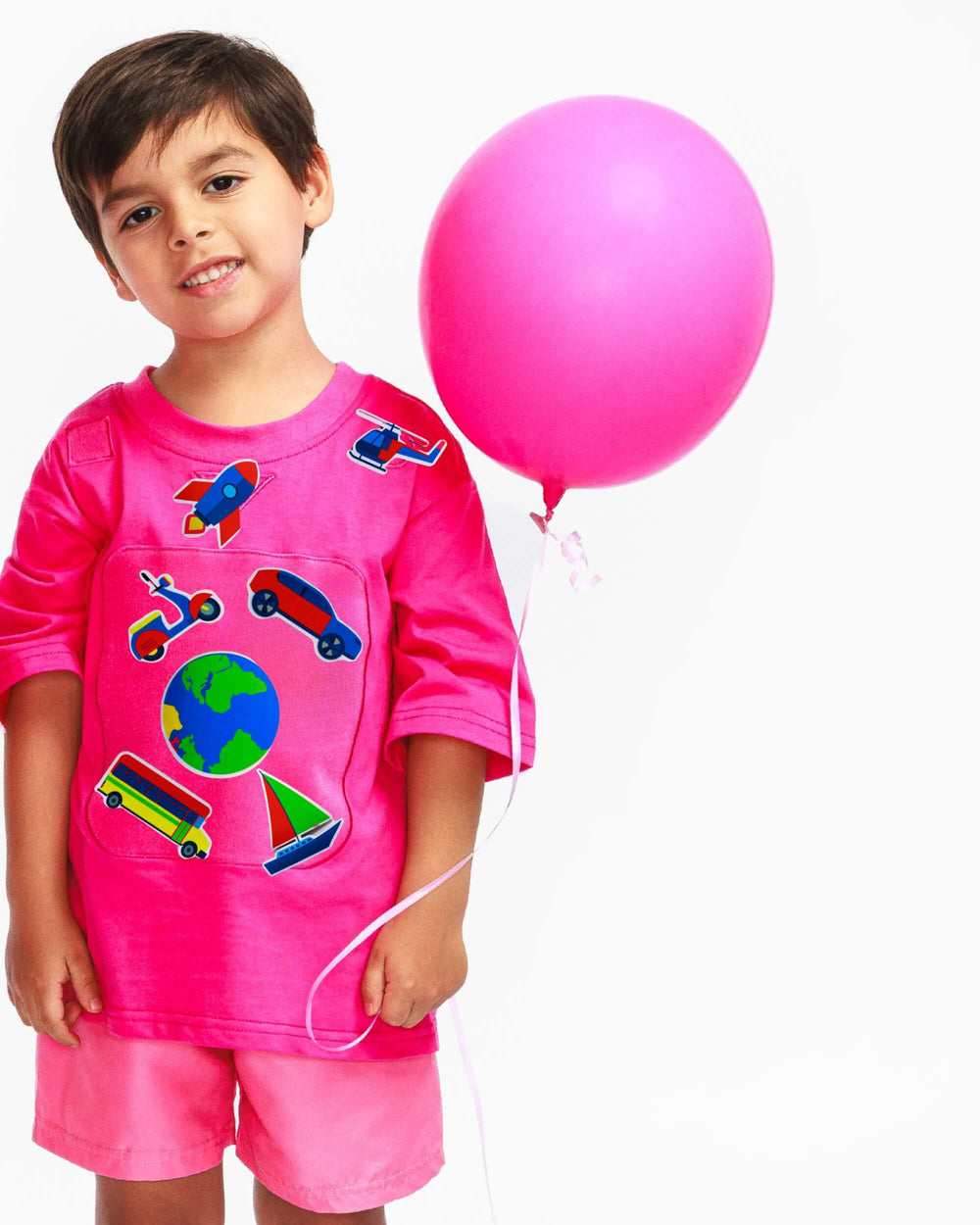 Boy wearing a pink TeeBoo™ interactive kids T-shirt with the SpeedyBoo BooPatch™ gift-ready set for creative screen-free play.