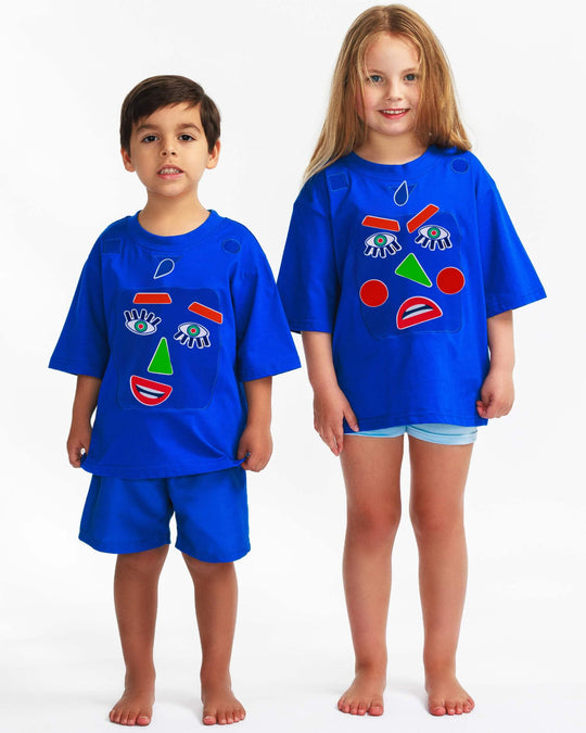 Boy and girl wearing a blue TeeBoo™ interactive kids T-shirt with the Moody Friends BooPatch™ gift-ready set for screen-free play.