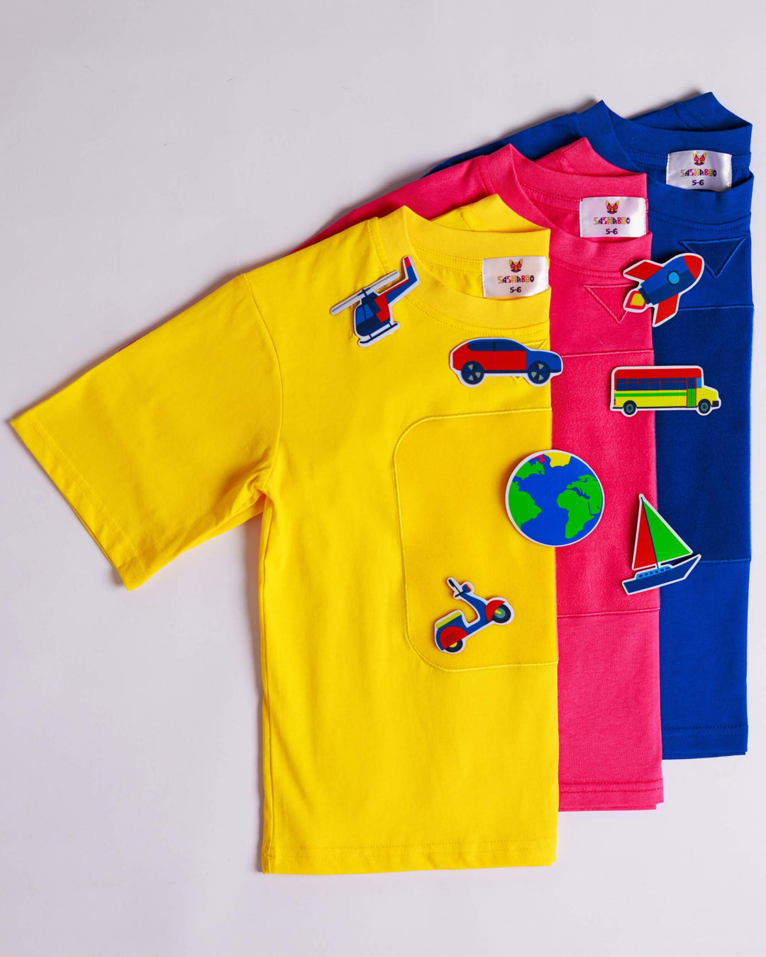 Yellow, blue and pink TeeBoo™ interactive kids T-shirts with the SpeedyBoo BooPatch™ gift-ready collection by SASHABOO.