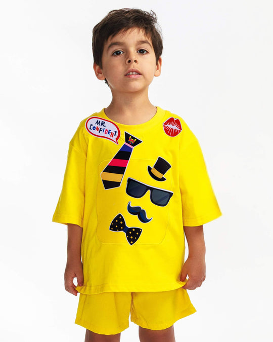 Boy wearing a yellow TeeBoo™ interactive kids T-shirt with the Mr. Confident BooPatch™ gift-ready set.