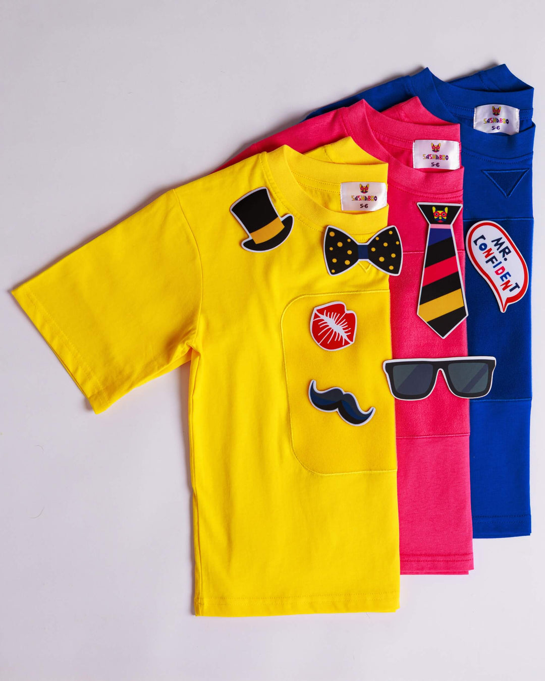 Yellow, blue and pink TeeBoo™ interactive kids T-shirts with the Mr. Confident BooPatch™ collection by SASHABOO.