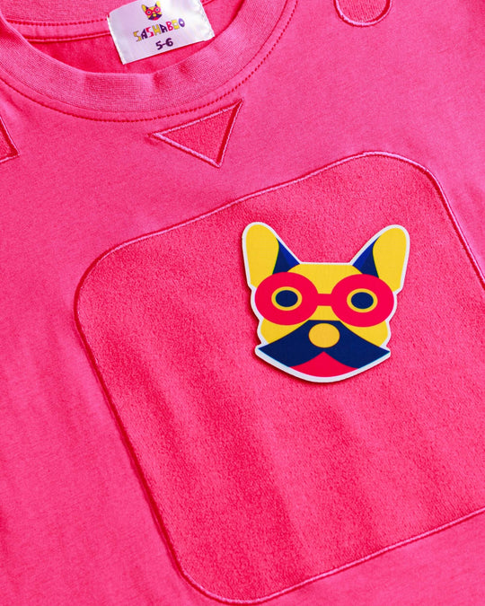 Close-up of the pink TeeBoo™ interactive kids T-shirt featuring the signature French Bulldog patch by SASHABOO.