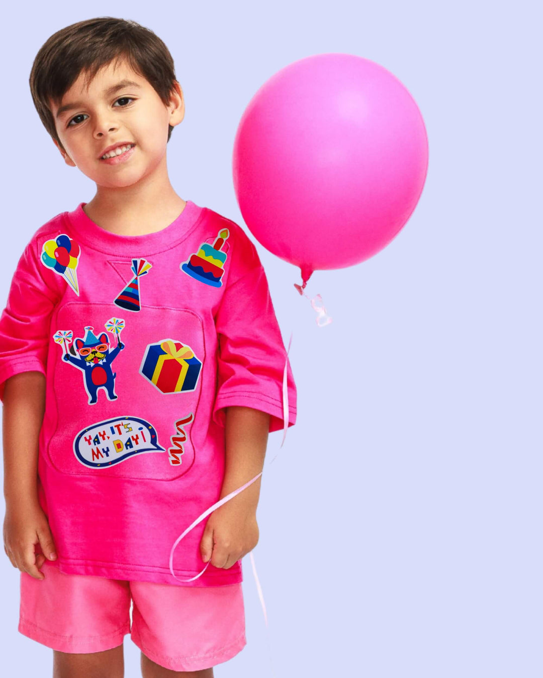 Boy wearing a pink TeeBoo™ interactive kids T-shirt with Yay, It's My Day! BooPatch™ gift set for imaginative, screen-free play.