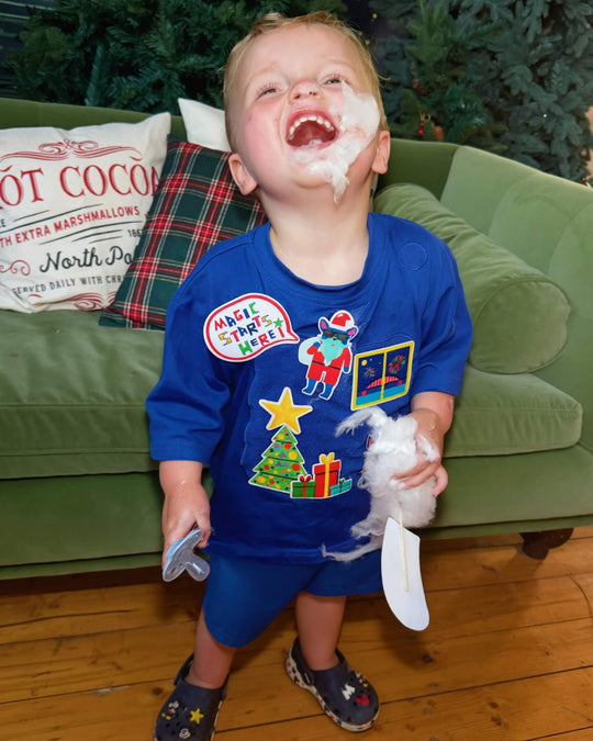 Child wearing a blue TeeBoo™ interactive T-shirt with Christmas BooPatch™